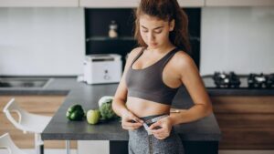 modelo medindo a circunferencia da cintura com uma fita